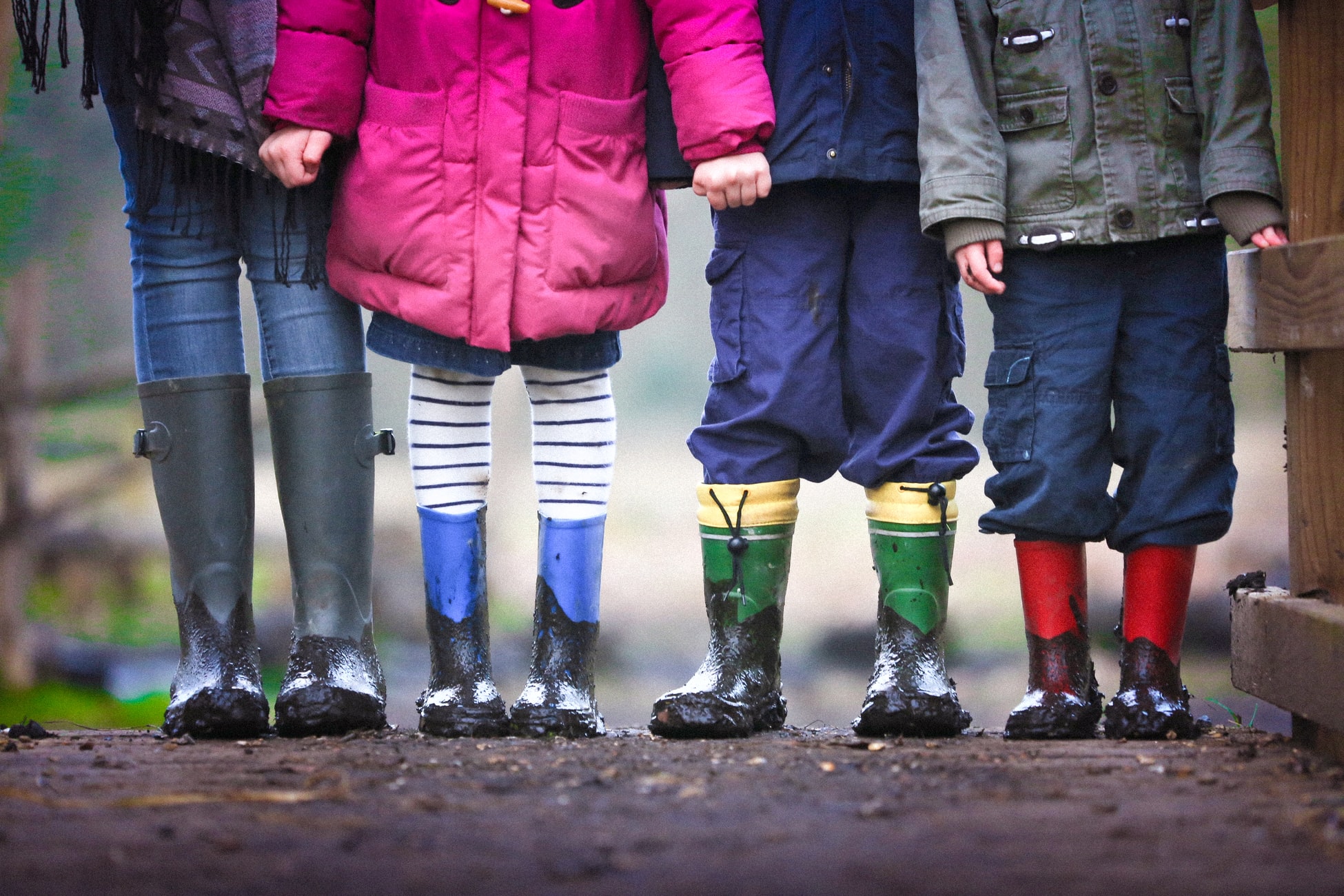 Preschool children in rain boots.
